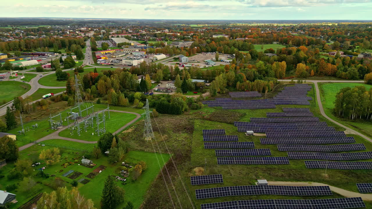 Expansive Solar Panel Field Situated Near a Suburban Area and Power Grid"