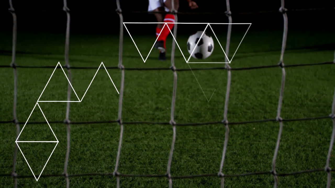 Kicking soccer ball with geometric animation overlay on green field