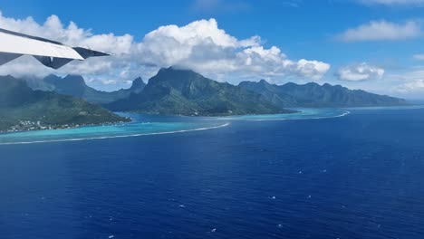 moorea island, french polynesia, airplane passenger pov of exotic coast, coral reefs and lagoon