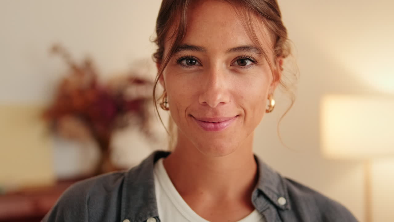 Close-up of Happy Young Woman Smiling at Camera