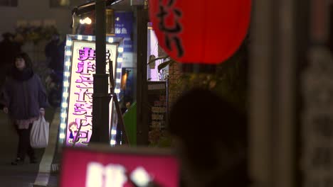 illuminated signs on tokyo sidewalk