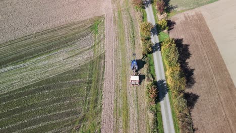 stunning aerial view flight pursuit flight drone of a
tractor on fall field by a road in brandenburg havelland germany at summer 2022