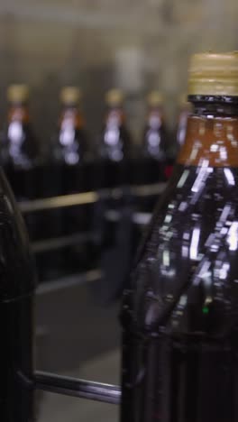 Dark Colored Beverage Bottles on a Production Line
