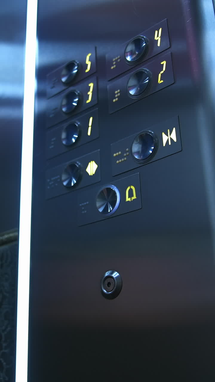 Man presses electronic button in lift. Man's hand touches elevator buttons in a hotel. Businessman in modern elevator. Close-up. Vertical video