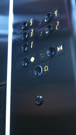 man presses electronic button in lift. man's hand touches elevator buttons in a hotel. businessman in modern elevator. close-up. vertical video
