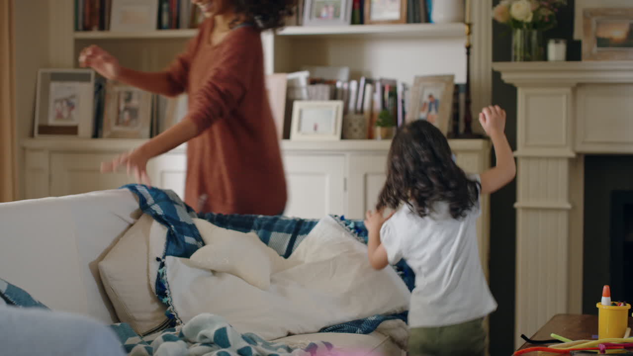 cute little girl playing catch with parents at home mother and father having fun running after child at home enjoying family time on weekend