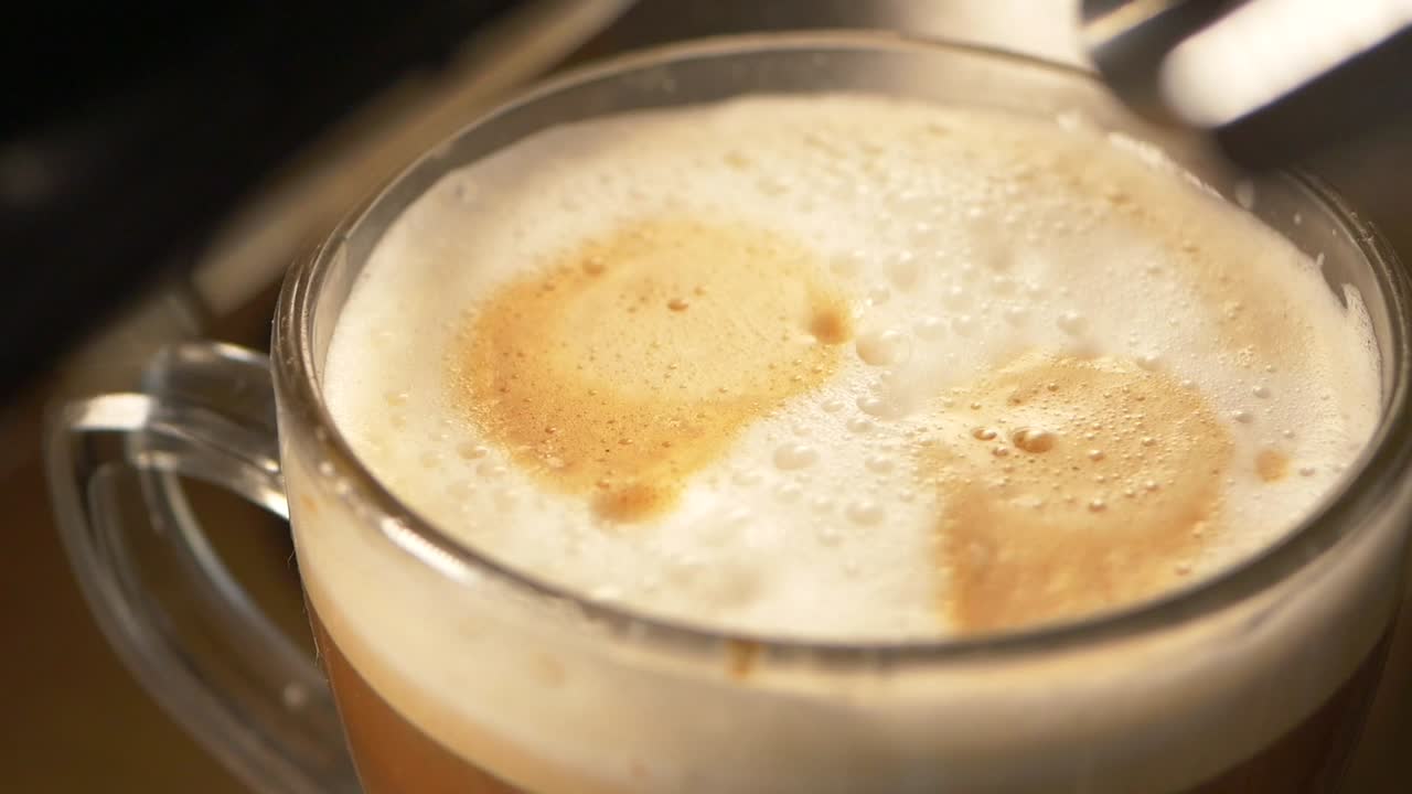 Close-up of a cappuccino in a glass cup