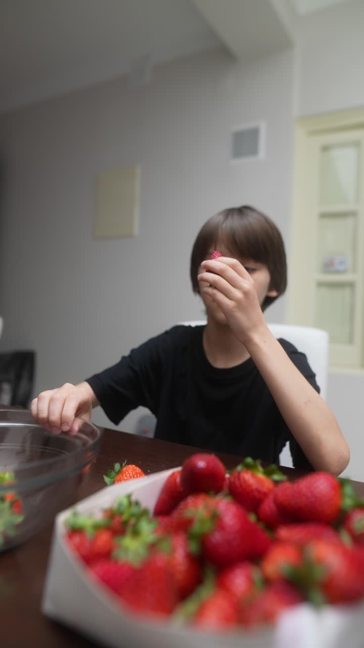 Boy eating strawberries