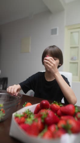 boy eating strawberries