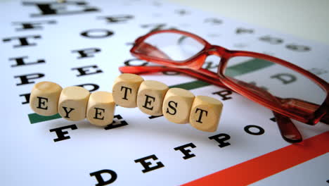 eye test dice falling onto eye test with red reading glasses