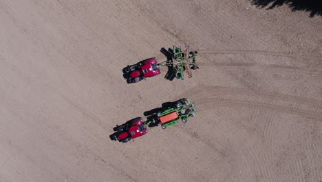 fixed zenithal drone shot showing tractor unfolding agricultural equipment in prague on a sunny day