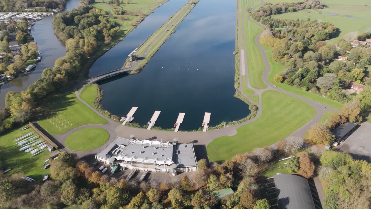 Rising aerial of Dorney Lake, capturing event venues, lake and River Thames in Windsor, Berkshire, UK