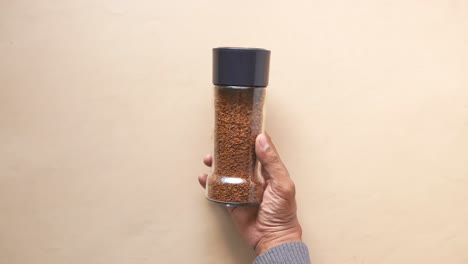 men holding a coffee powder jar on table