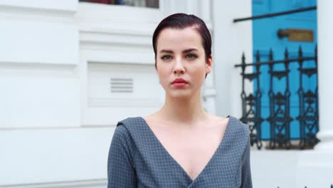 fashion conscious young woman standing outdoors on city street