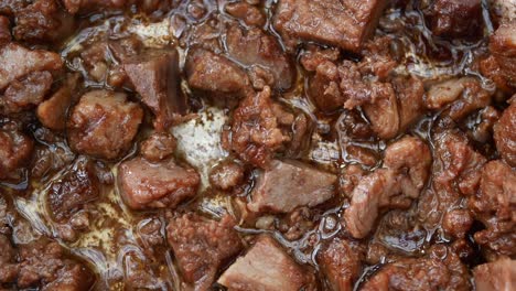 close-up of browned beef cubes in a pan