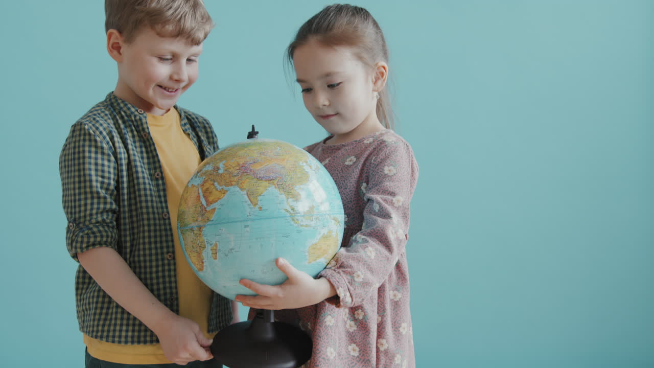 Portrait of Adorable Girl and Boy with World Globe