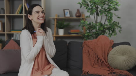 happy woman receiving positive pregnancy test result