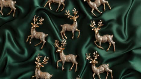 gold deer ornaments on green silk fabric