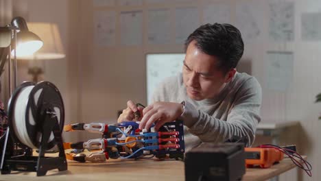 man working on a robotic hand