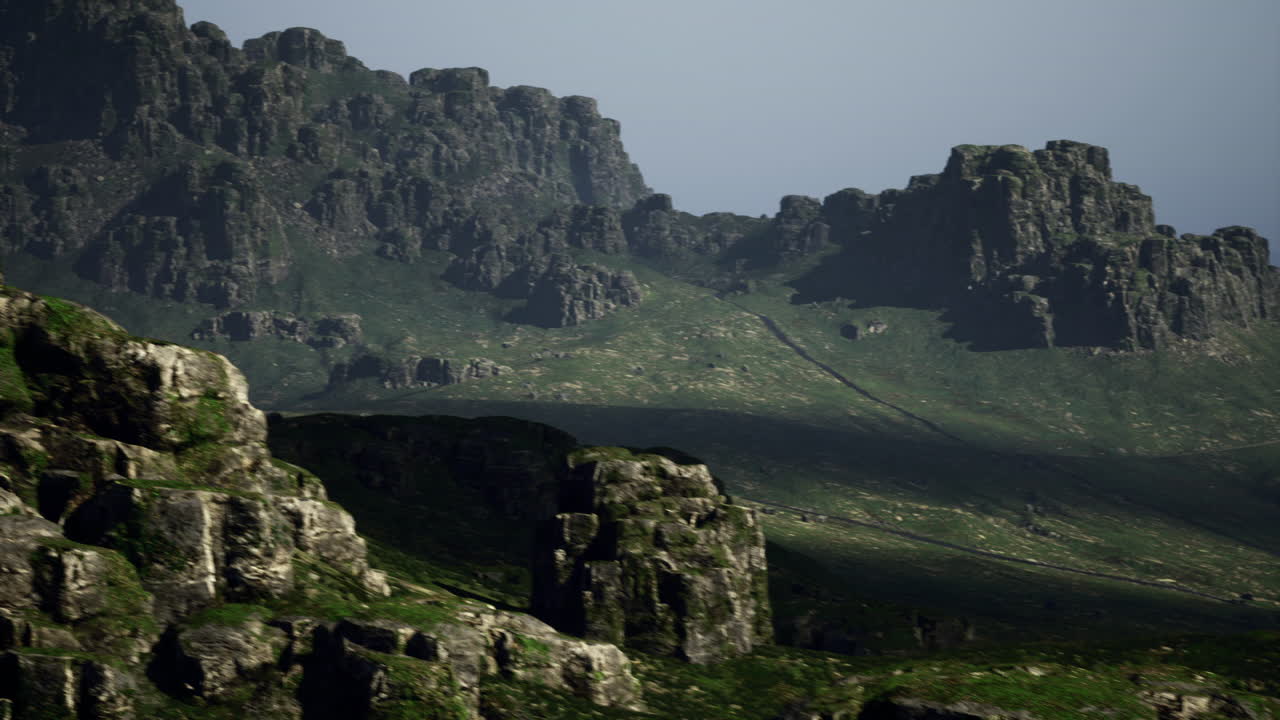 Mountain landscape with rugged rocks and valleys under soft light conditions