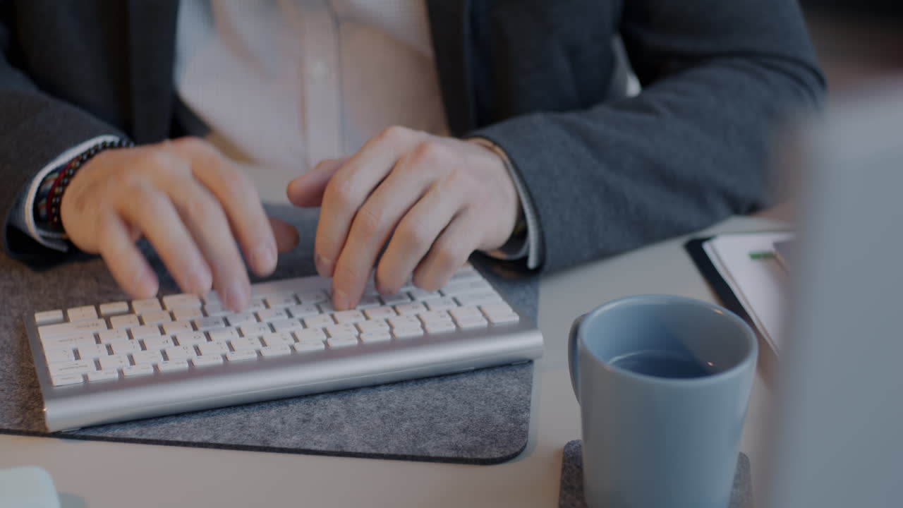 Businessman Typing on Keyboard in Office