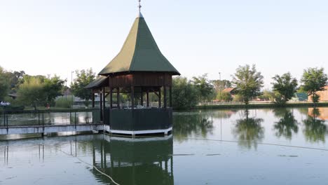 gazebo on dock in middle of small pond at event venue, ready for wedding