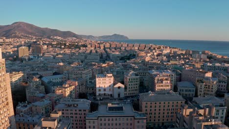 Vista-De-Retroceso-Del-Atardecer-De-Drones-Sobre-El-Horizonte-De-Génova,-Liguaria,-Italia