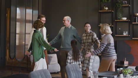 Happy-Family-Standing-Embracing-All-Toghether-In-Circle-At-Home