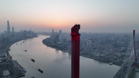 drone aerial view of sunset and the landmark bridge in shanghai china