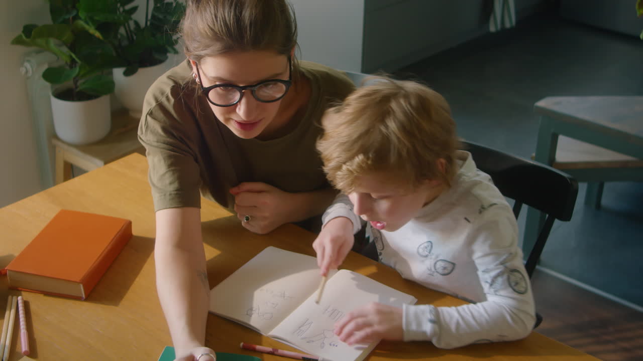 Mother and Little Son Studying at Home