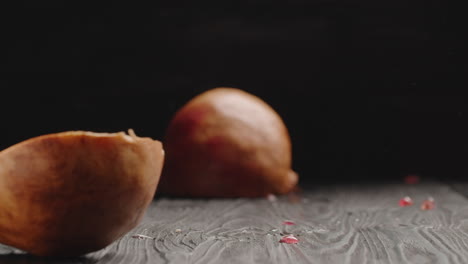 cutting juicy pomegranate in half