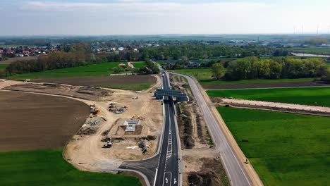 AERIAL---Railroad-construction-and-farmland-in-Baden,-Austria,-forward-wide-shot