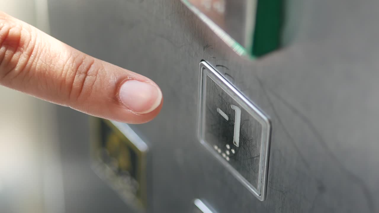 Hand Pressing Elevator Button to Floor -1