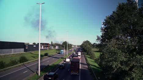 Cars-moving-slowly-on-highway-road-because-of-accident-with-black-smokes