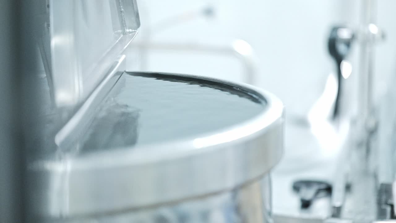 A large stainless steel water tank in a factory