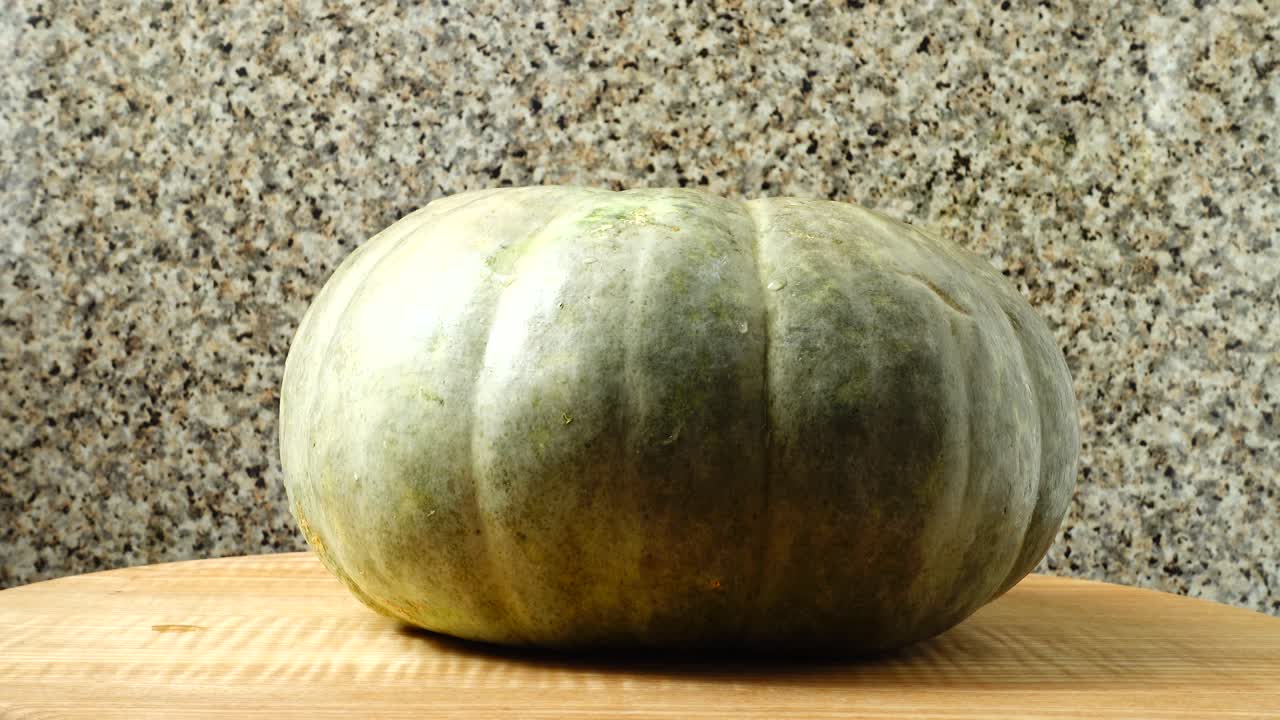 Pumpkin on a kitchen board. Shooting in the movement. Shooting in the movement