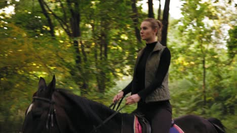 Young-cowgirl-rides-a-horse-during-sunny-day-in-the-forest.-Galloping-in-the-forest