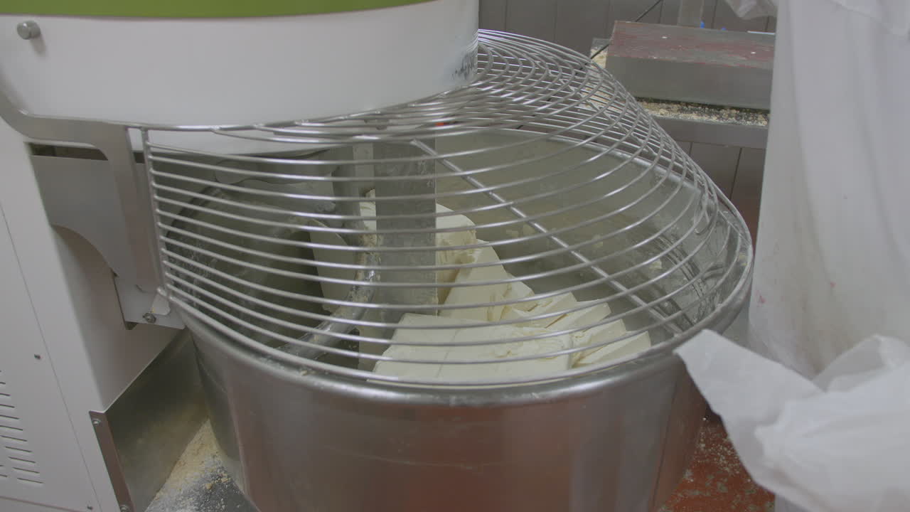 Slabs of icing mixture are added to an industrial cake mixer which is turned on