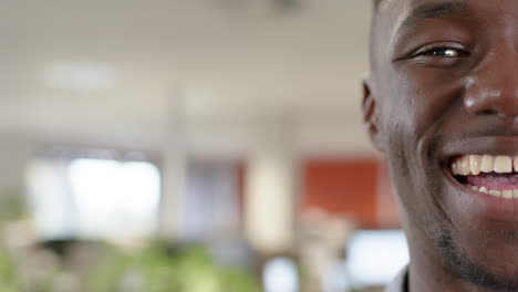 Portrait-of-casual-african-american-businessman-smiling-in-office,-slow-motion-with-copy-space