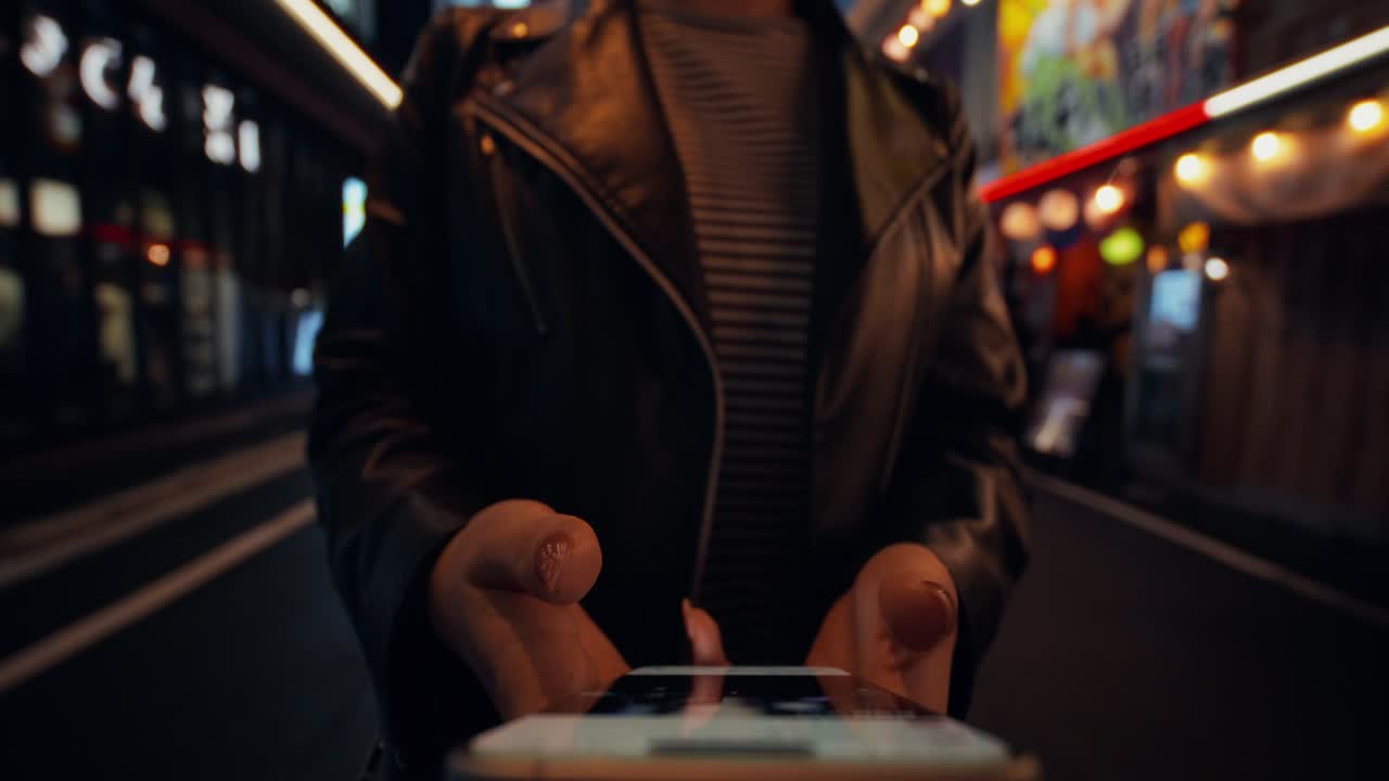 Woman using phone in a Japanese city at night
