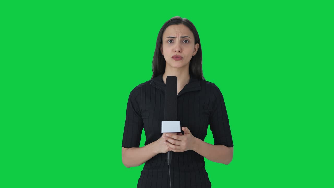 Angry Indian female news reporter shouting on camera Green screen