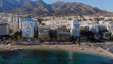 drone shot coming in to the beach in marbella, spain