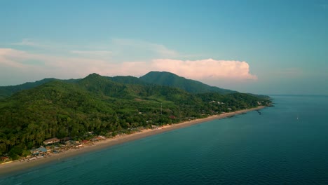 4K-Cinematic-nature-drone-footage-of-a-panoramic-aerial-view-of-the-beautiful-beaches-and-mountains-on-the-island-of-Koh-Lanta-in-Krabi,-South-Thailand,-during-sunset