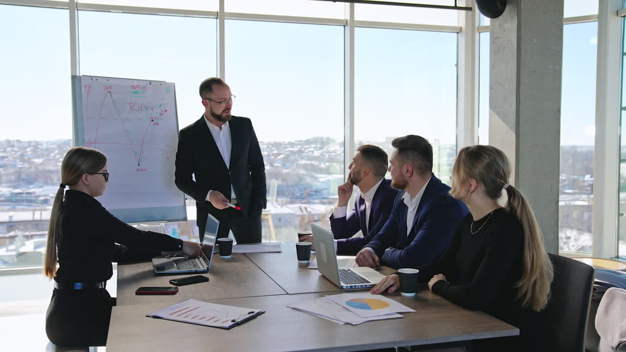 Business team discussing business project. Briefing for the office workers at the table in a spacious office.