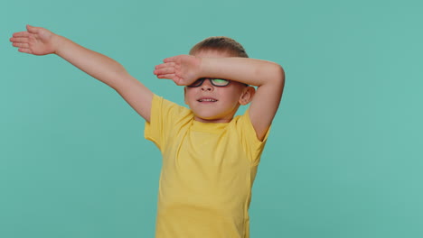 Trendy-cheerful-toddler-children-boy-dancing,-moving-to-rhythm,-dabbing-raising-hands,-dubdance