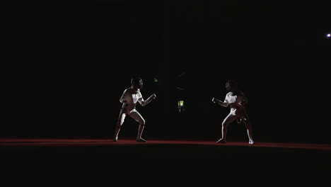 two fencers compete in a match