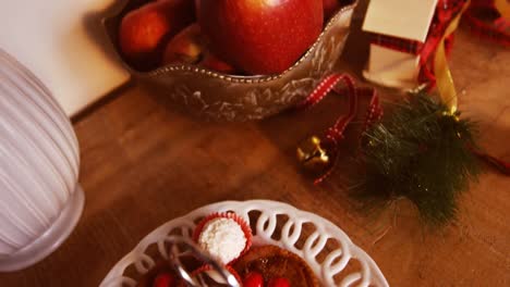 Various-christmas-desserts-and-decorations-on-wooden-table