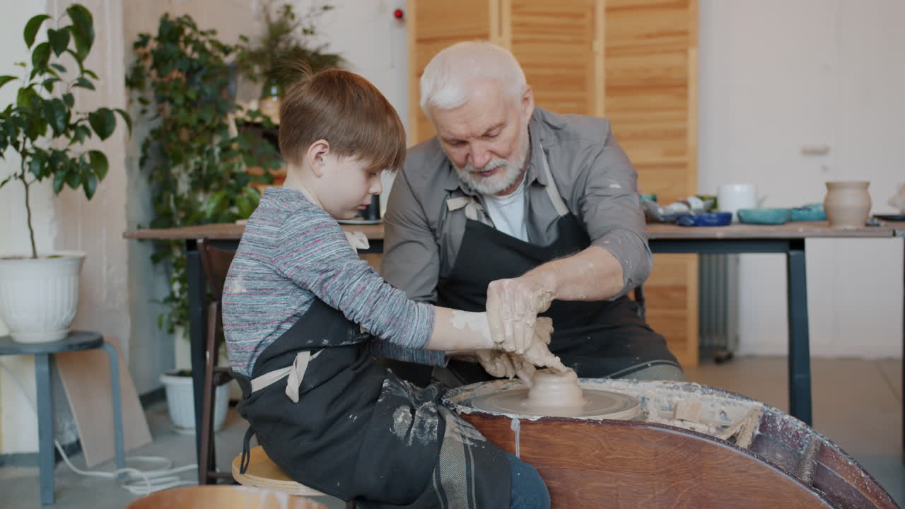Grandfather and grandson learning pottery