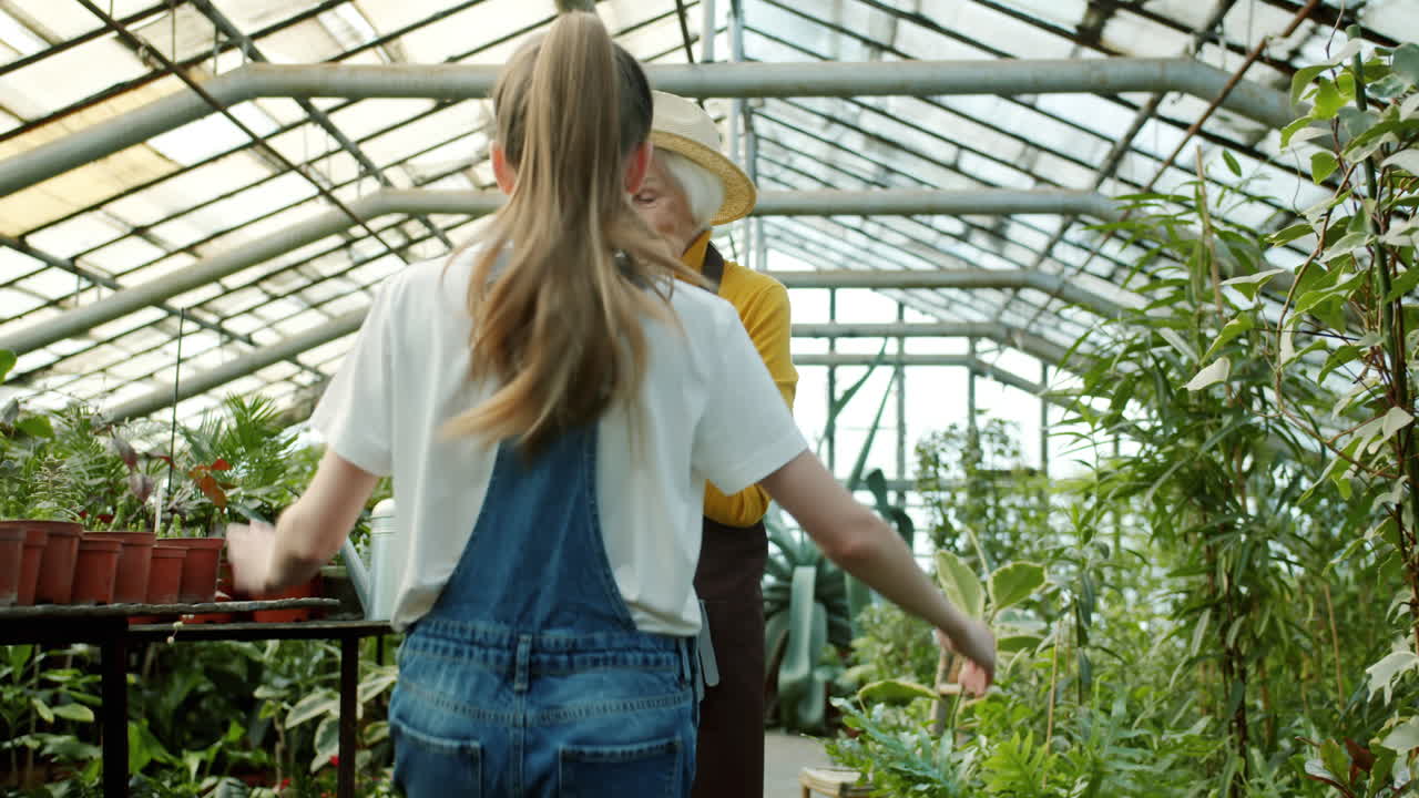 Grandmother and Granddaughter in a Greenhouse