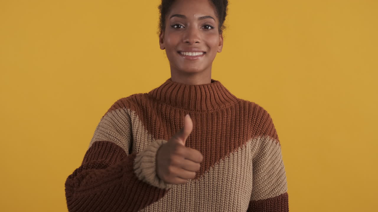Happy black woman giving thumb up